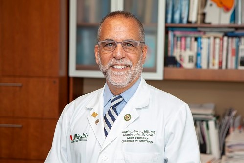 Portrait photo of Dr Ralph Sacco, former president of the American Academy of Neurology, in his office, wearing a white lab coat