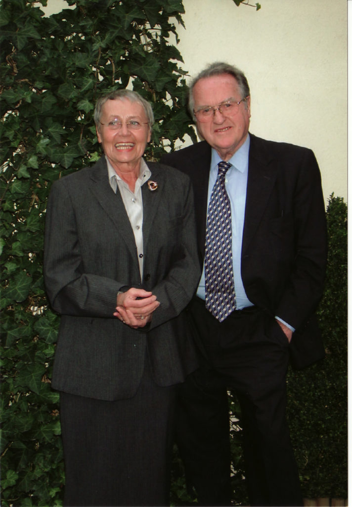 Woman and man, standing, posing for photo