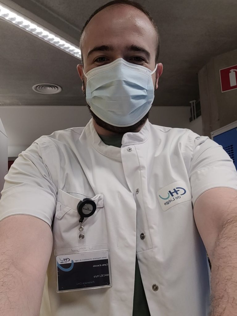 Selfie taken by man in white hospital uniform and mask