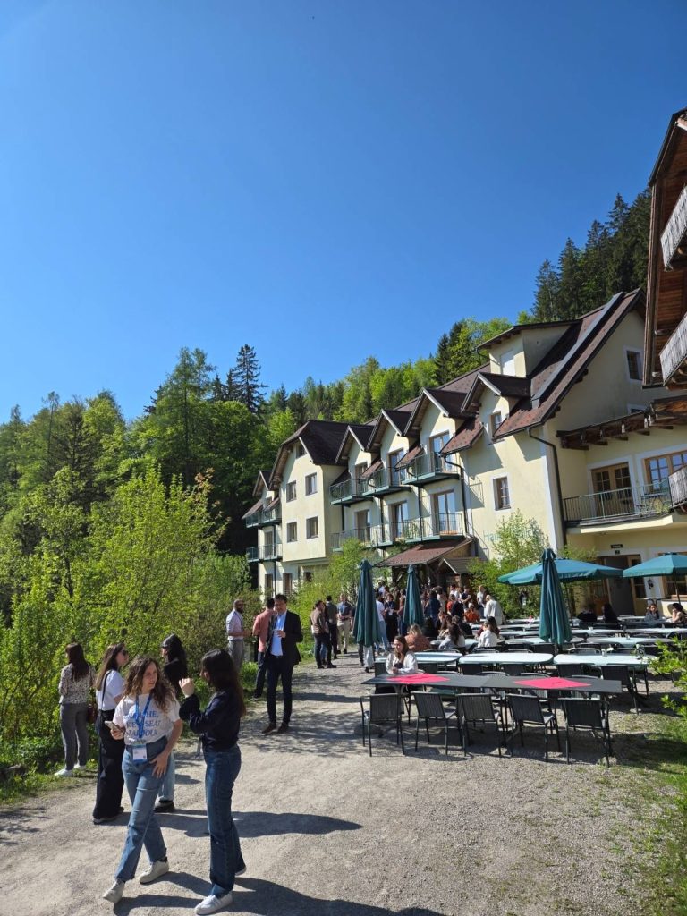 Building in rural Austria with course participants taking a break outside